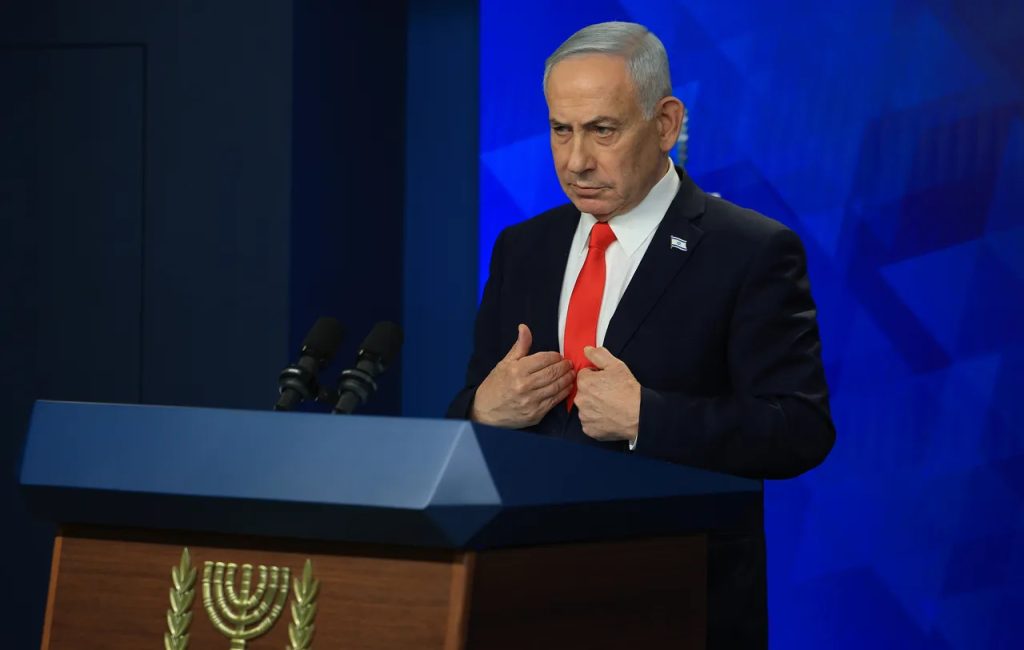 Israeli Prime Minister Benjamin Netanyahu speaking at a podium.