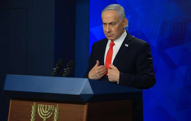 Israeli Prime Minister Benjamin Netanyahu speaking at a podium.