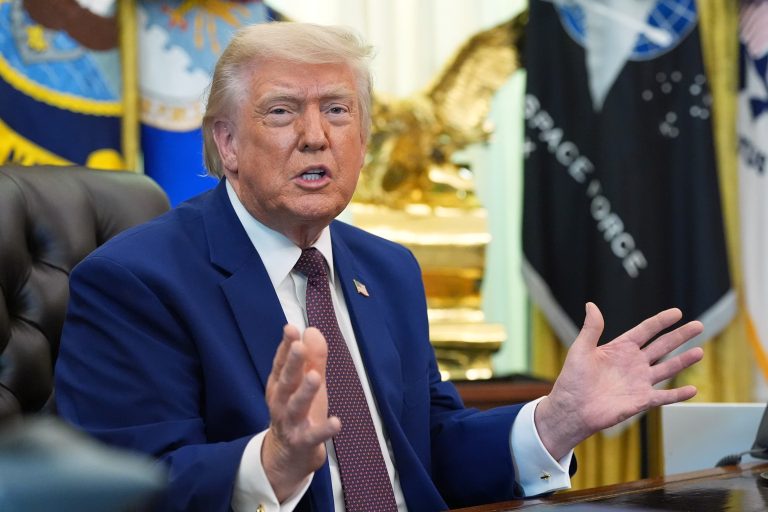 Donald Trump speaking during an official briefing, gesturing with his hands.