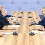 A high-level diplomatic meeting between Russian and Turkish officials around a conference table.