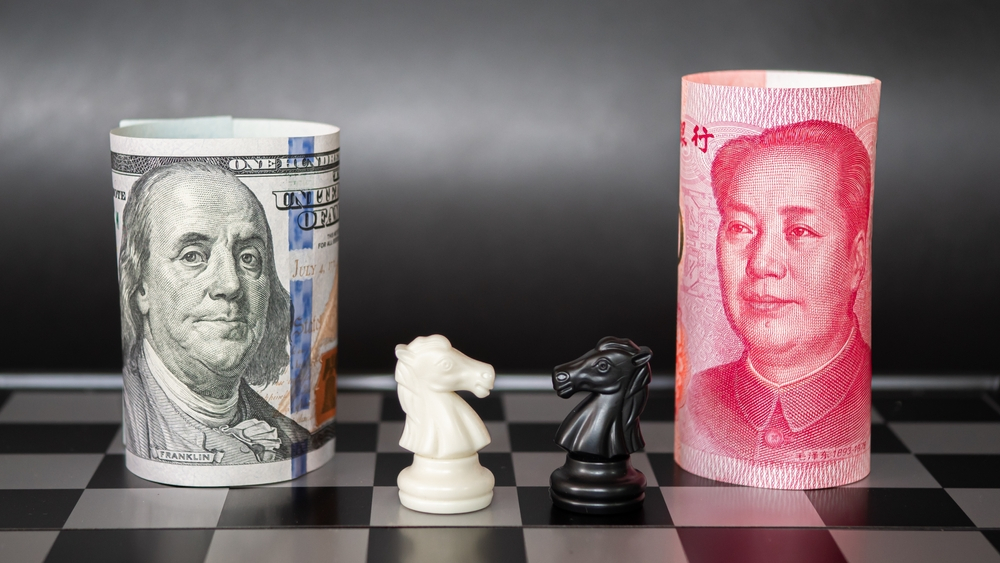 A chess board featuring a US dollar bill and a Chinese yuan bill facing off with knight pieces.