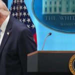 Former President Donald Trump walking away from a podium with the White House seal in the background.