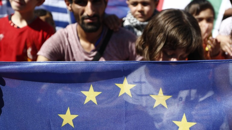 People holding a European Union flag during a protest.