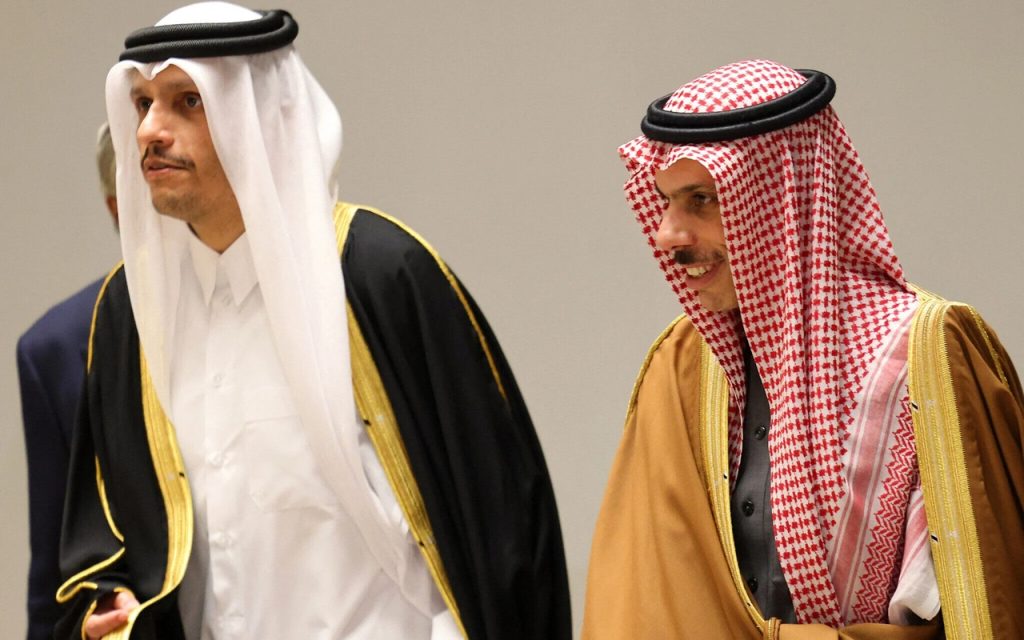 Officials in traditional Gulf Arab attire engaged in diplomatic discussions.