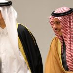Officials in traditional Gulf Arab attire engaged in diplomatic discussions.