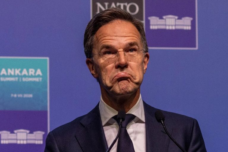 Mark Rutte appearing concerned while speaking at a podium with NATO branding in the background.
