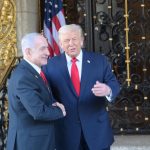 Donald Trump and Benjamin Netanyahu shaking hands outside a building.