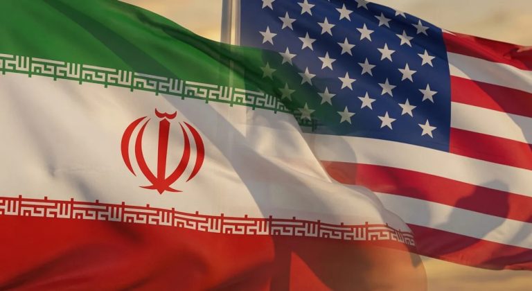 The flags of the United States and Iran waving side-by-side in the wind.