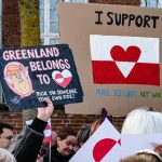 Protesters holding signs in Copenhagen expressing opposition to the potential U.S. purchase of Greenland.