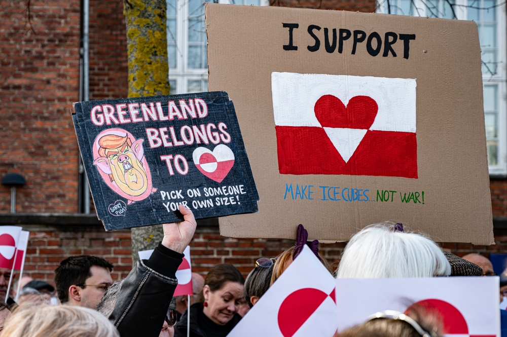 Protesters holding signs in Copenhagen expressing opposition to the potential U.S. purchase of Greenland.