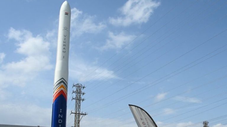 Skyroot Aerospace Vikram-1 rocket standing vertically against a blue sky at a launch facility in India.
