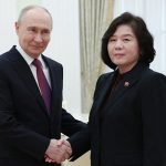 Vladimir Putin shaking hands with North Korean official Choe Son-hui during a formal meeting.