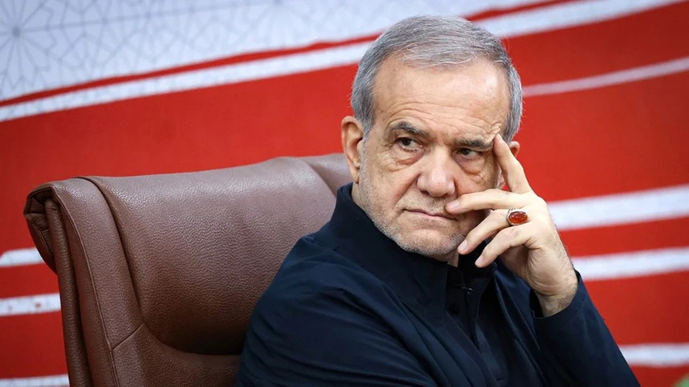 Masoud Pezeshkian resting his head on his hand while seated in a chair.