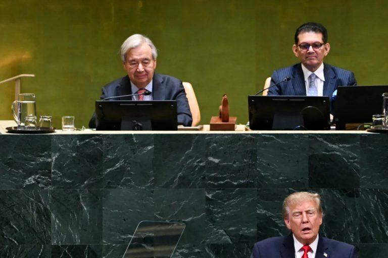 Donald Trump speaking at the UN podium below seated United Nations officials.