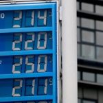 A fuel price display board showing high prices for Super E10, Super, Ultimate 102, and Diesel.