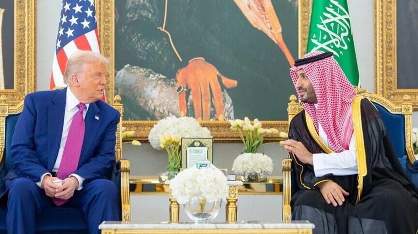 Donald Trump speaking with Saudi Crown Prince Mohammed bin Salman in an ornate diplomatic reception room.