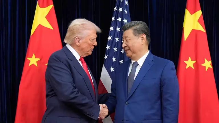 Donald Trump and Chinese President Xi Jinping shaking hands in front of US and Chinese flags.