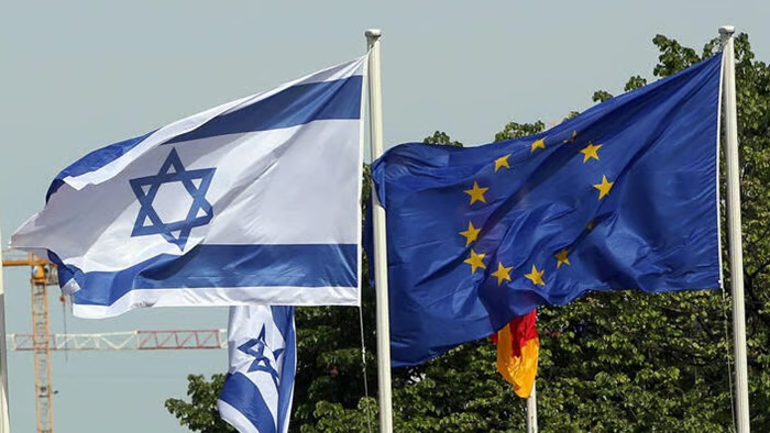 The flags of Israel and the European Union waving side by side on flagpoles.