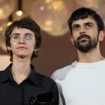 Filmmakers Basel Adra and Yuval Abraham standing together at an awards ceremony.