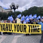 Protesters holding a large yellow banner reading "Netanyahu, Your Time Is Up" surrounded by Israeli flags.