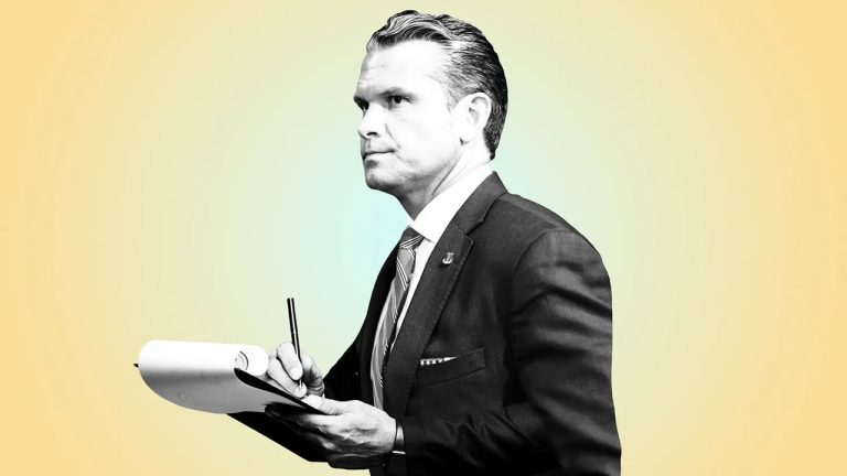 Pete Hegseth holding a notepad and pen in a suit.