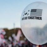 A white balloon printed with the US and South Korean flags and the phrase WE GO TOGETHER.