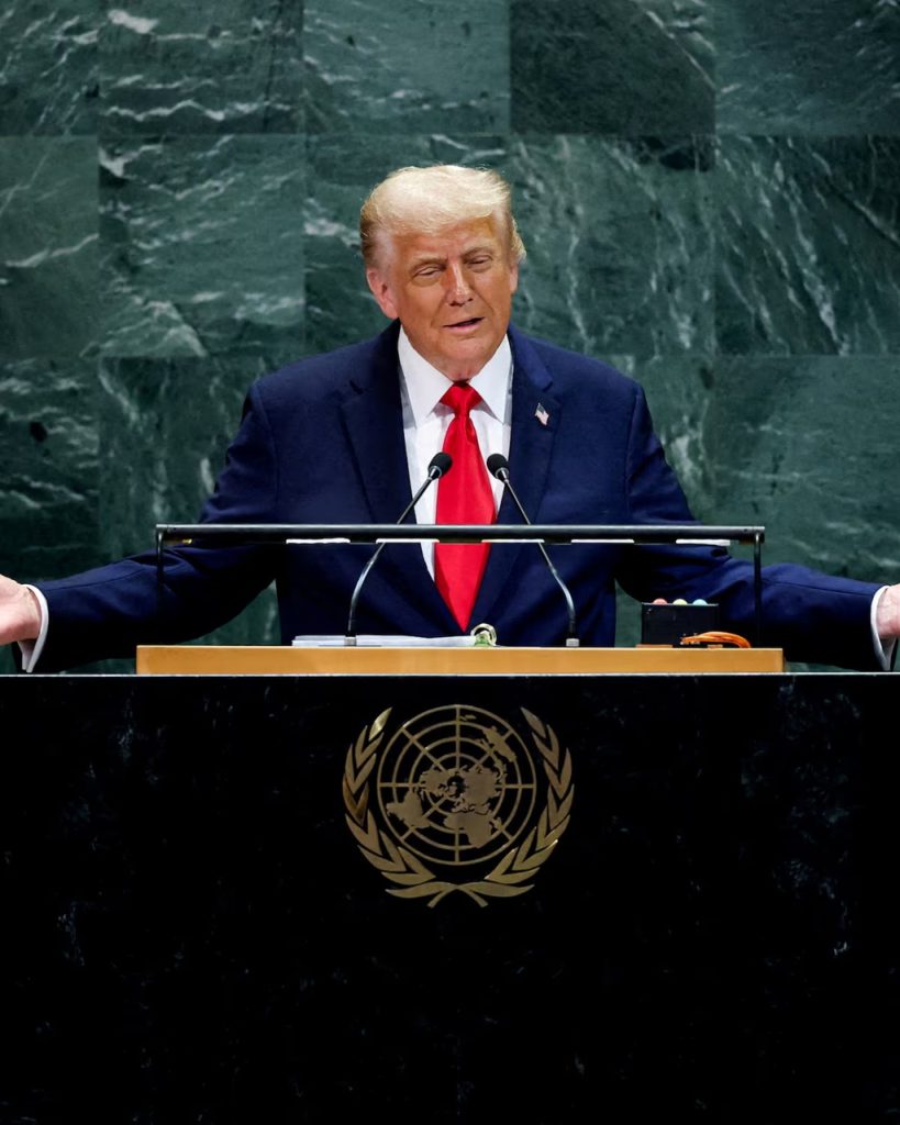 Donald Trump gesturing with open arms at the UN podium.
