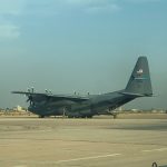US Air National Guard C-130 Hercules transport aircraft parked on a desert runway tarmac.