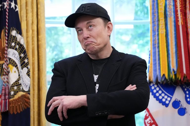 Elon Musk wearing a black blazer and a black baseball cap with "DOGE" lettering, standing with his arms crossed and rolling his eyes upward.