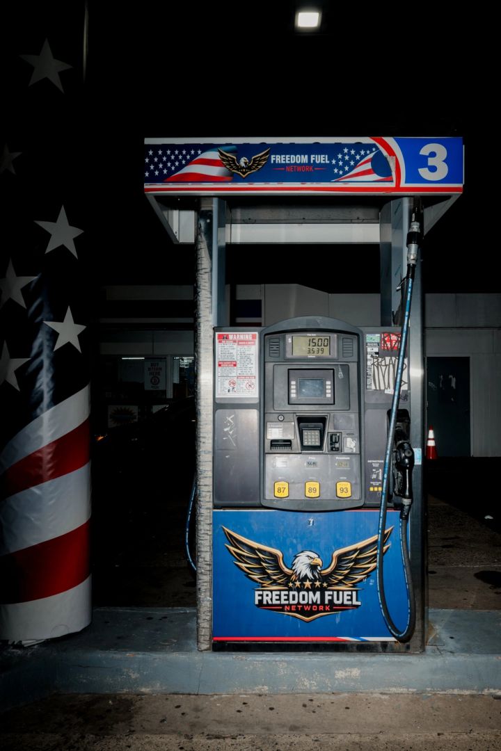 A digital gas pump at night branded with Freedom Fuel Network and an American flag theme.