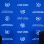 Ukrainian President Volodymyr Zelenskyy and Donald Trump seated in front of a blue United Nations backdrop.