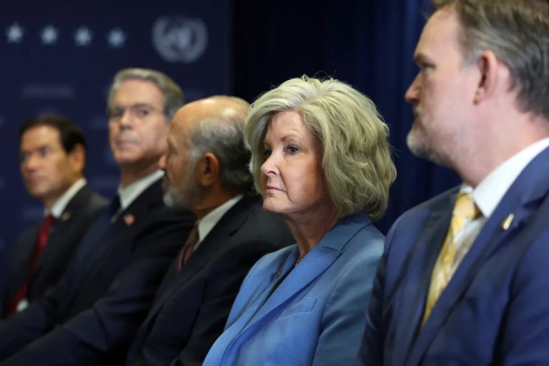 White House Chief of Staff Susie Wiles and senior Trump administration officials seated in a row with serious expressions.