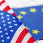 Close-up of the American flag placed over the European Union flag.