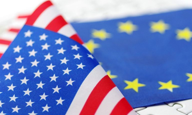 Close-up of the American flag placed over the European Union flag.